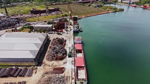 Cargo ship docked at industrial area near water body in daytime Stock Footage 338325834