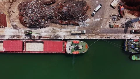 Cargo ship is docked at port while loading materials for transport 動画素材 338325903