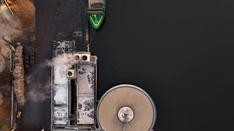 Cargo ship docking at paper mill for wood chip delivery Stock Footage 297055402