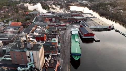 Cargo ship docking at paper mill industrial complex Stock Footage 297056825
