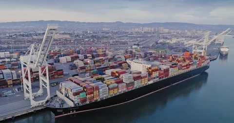 Cargo ship docks at a busy Port Of Oakland, with Oakland, USA view. Stock Footage 87067887