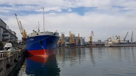 Cargo ship during unloading and loading in an industrial port, in the background Stock Footage 148859935