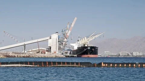 Cargo ship in the Eilat port, in the background can be seen the city of Eilat Stock-Footage 90353641