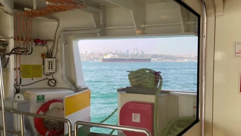 Cargo ship from the ferry window Stock Footage 240314141