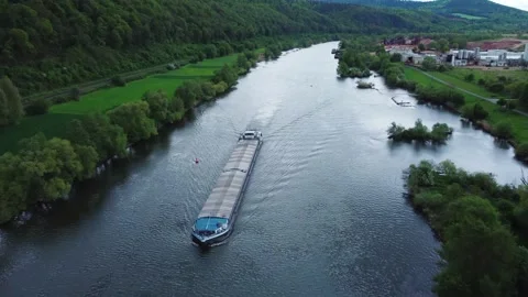 Cargo ship floats on the river through the field top view 動画素材 154376513