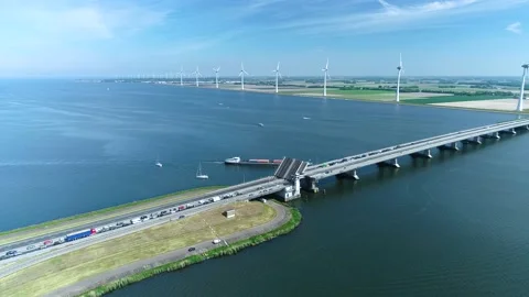 Cargo Ship Going Under a Bridge between Lakes - Flevoland, Holland, 4K Drone Stock Footage 145927216