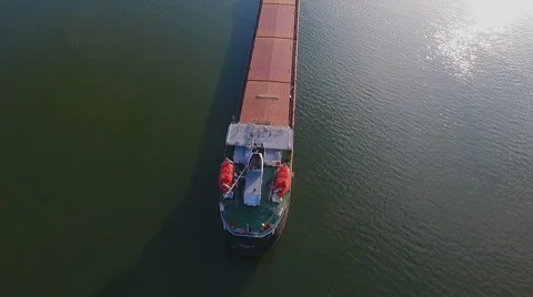 Cargo ship in green river water. Stock Footage