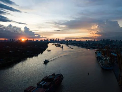 Cargo ship in the harbor at sunset Stock Photos