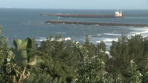 Cargo ship leaving Richards Bay harbor Stock Footage 11526069