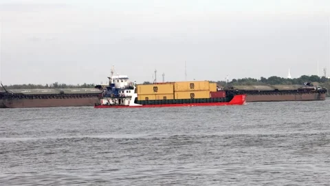 The cargo ship loaded with containers, passed the towed boats Stock Footage 240221724