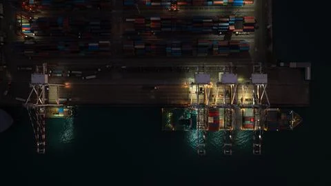 Cargo Ship Loading Containers At Industrial Port Terminal At Night Wide Ang.. 库存照片