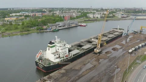 Cargo Ship Loading Multiple Shipping Containers from semi 動画素材 209615736