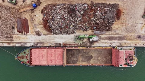 Cargo ship loading scrap metal at port on a sunny day in October 動画素材 338324131