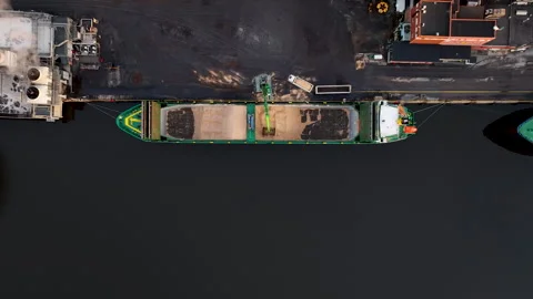 Cargo ship loading wood chip at industrial port paper mill Stock Footage 297054803