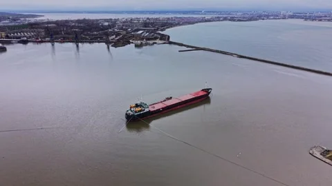 Cargo ship moves through the water near the shipyard in the harbor Stock Footage 337940752