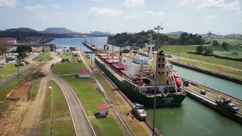 A cargo ship is moving slowly through the Panama Canal Stock Footage 169864323