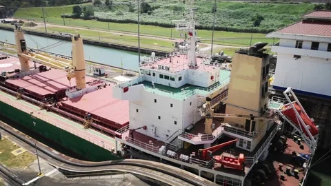 A cargo ship is moving slowly through the Panama Canal Stock Footage 169864326
