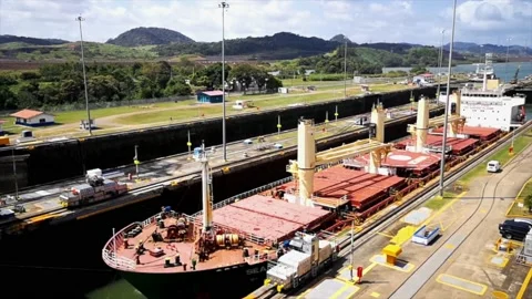 A cargo ship is moving slowly through the Panama Canal Stock Footage 169864344
