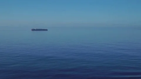 Cargo ship is moving through the calm sea. Stock Footage 77364238