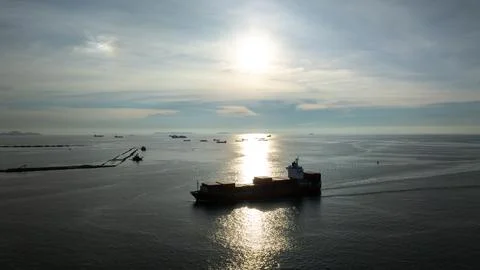 Cargo Ship Navigating Calm Sea At Sunset Near Laem Chabang Thailand Wide Shot Stock-Fotos