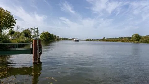 Cargo ship navigating the Maas river in the region of Limburg Stock Photos