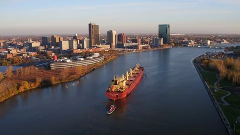 A cargo ship passes through the Maumee river towards downtown Toledo, Ohio. Stock Footage 100657237