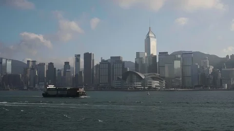 Cargo Ship passing in front of Hong Kong Central Plaza Stock Footage 128862863