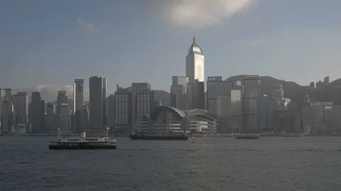 Cargo Ship passing in front of Hong Kong Central Plaza Stock Footage 128863198