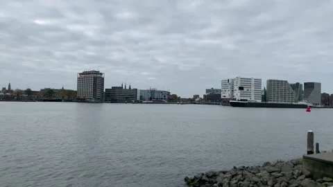 Cargo ship is passing through IJ bay, river. Amsterdam, Netherlands Stock Footage 161027031