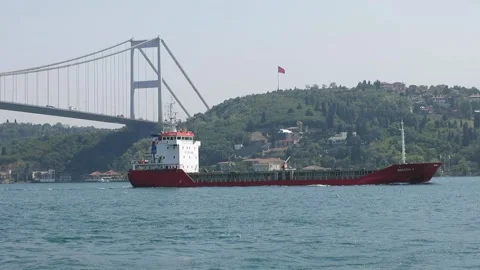 A cargo ship is passing under the Fatih Sultan Mehmet bridge in Istanbul. Stock Footage 130257753