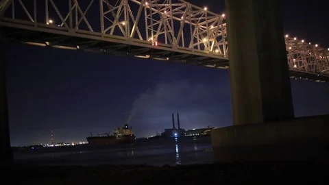 A cargo ship passing under the I-10 bridge in New Orleans Stock Footage 72716956