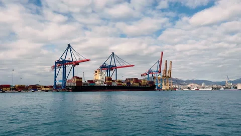 Cargo ship at the port, carrying containers with the cranes Stock Footage 196932050