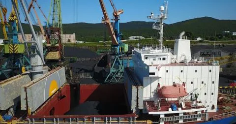 The Cargo Ship is in the Port Pier at the Loading of Coal Stock Photos
