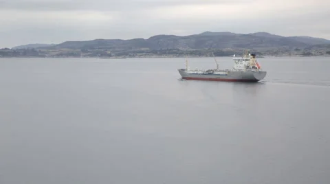 Cargo ship proceeding out from the port Stock Footage 63319737