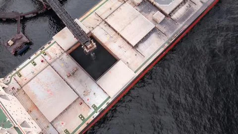 Cargo ship in the process of loading minerals from a mine for export Stock Photos