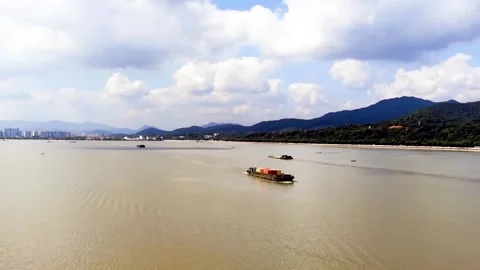 Cargo Ship on Qiantang River with Distant City Skyline and Mountains Stock Footage 342229137