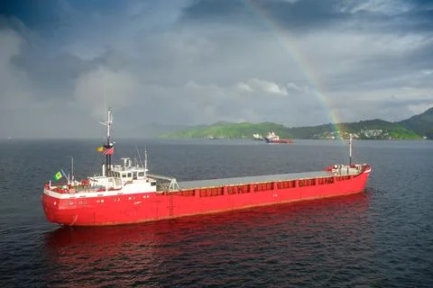 Cargo ship in rainbow Stock Photos
