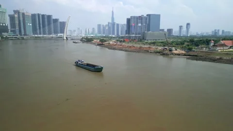 Cargo ship on the Saigon River and Ho Chi Minh City skyline, Vietnam Stock Footage 264952757