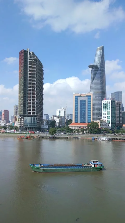 Cargo ship on the Saigon River and Ho Chi Minh City skyline, Vietnam Stock Footage 264952771