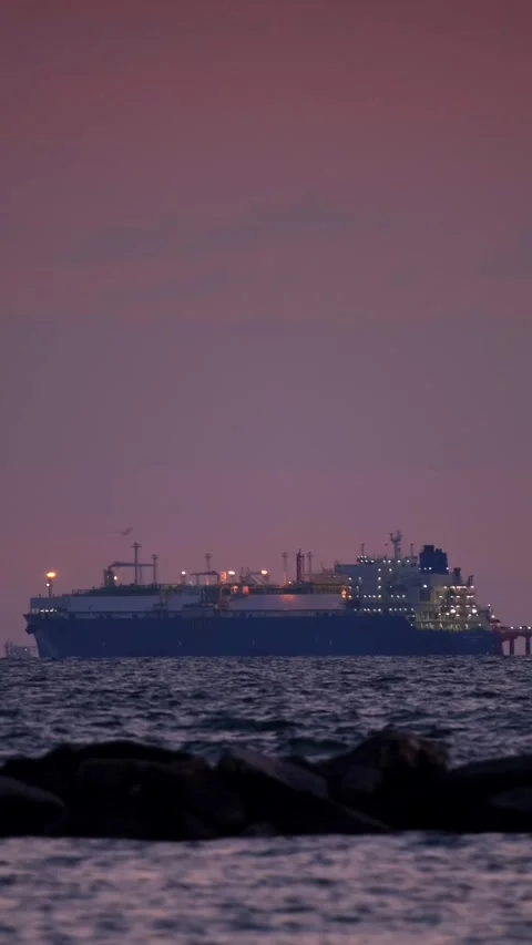 Cargo ship sailing in calm waters at twilight Stock Footage 345226487