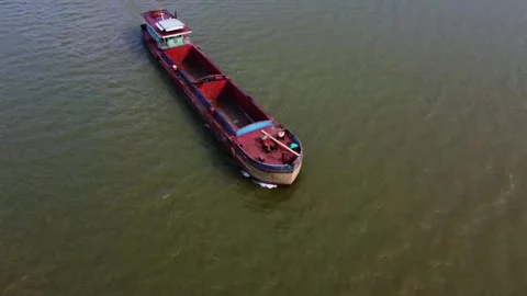 A cargo ship sailing down a river Stock Footage 242515811
