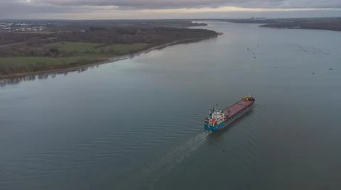 A cargo ship sailing down the River Orwell in Suffolk, UK 写真素材