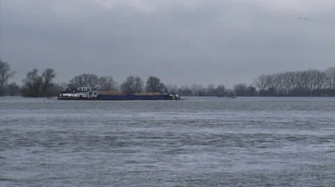 Cargo ship sailing on flooded river IJssel, The Netherlands + zoom out Stock Footage 23733900