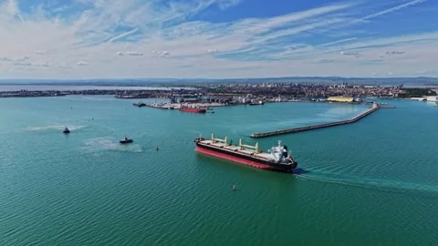 Cargo ship sailing in harbor during bright daytime with clear sky 스톡 동영상 339018937