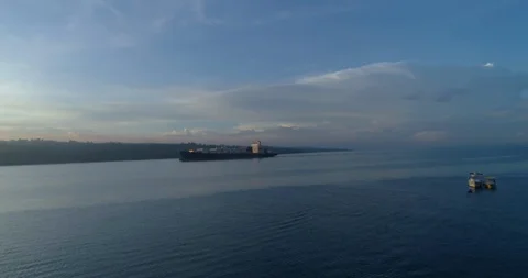 Cargo ship sailing in the lake at sunset Stock Footage 107564277