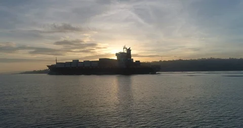 Cargo ship sailing in the lake at sunset Stock Footage 107564472
