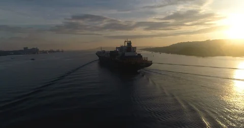 Cargo ship sailing in the lake at sunset Stock Footage 107564741