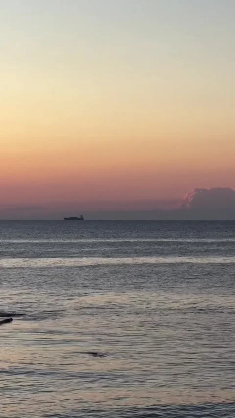 Cargo ship sailing on ocean horizon at sunset Stock-Footage 339883084