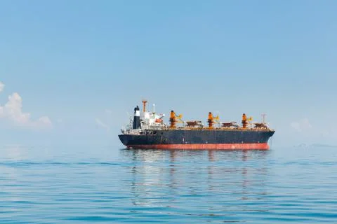 Cargo ship sailing in ocean Stock Photos
