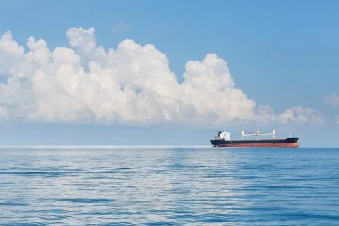 Cargo ship sailing in ocean Stock Photos